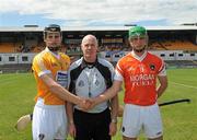 27 June 2010; Antrim captain Mathew Donnelly and Armagh captain Paddy Heaney shake hands in front of referee Jim O'Rourke, Monaghan. ESB Ulster GAA Hurling Minor Championship Final, Antrim v Armagh, Casement Park, Belfast. Picture credit: Michael Cullen / SPORTSFILE