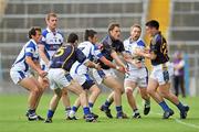 27 June 2010; Brian Coen, right, receives the ball from Niall Curran, 3, Tipperary, despite the attention of Laois players Cahir Healy, right, and Craig Rogers, centre. GAA Football All-Ireland Senior Championship Qualifier Round 1, Tipperary v Laois, Semple Stadium, Thurles, Co. Tipperary. Picture credit: Barry Cregg / SPORTSFILE