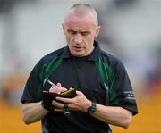 26 June 2010; Referee Martin Higgins takes the name of a player during the game. GAA Football All-Ireland Senior Championship Qualifier Round 1, Offaly v Clare, O'Connor Park, Tullamore, Co. Offaly. Picture credit: Brendan Moran / SPORTSFILE
