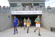 26 June 2010; The Offaly team, led by captain Karol Slattery, 7, Anton Sullivan, 13, and Niall McNamee, 15, make their way out onto the pitch for the second half alongside Clare substitute goalkeeper Keith Ryan. GAA Football All-Ireland Senior Championship Qualifier Round 1, Offaly v Clare, O'Connor Park, Tullamore, Co. Offaly. Picture credit: Brendan Moran / SPORTSFILE