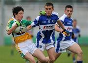 30 June 2010; Paul McPadden, Offaly, in action against Shane McCauley and Ruairi Dunne, right, Laois. ESB Leinster GAA Football Minor Championship Semi-Final, Offaly v Laois, O'Connor Park, Tullamore, Co. Offaly. Picture credit: Brian Lawless / SPORTSFILE