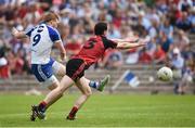 5 June 2016; Kieran Hughes of Monaghan shoots to score his side's second goal despite the attempted tackle of Gerard McGovern of Down in the Ulster GAA Football Senior Championship Quarter-Final between Monaghan and Down in St Tiernach's Park, Clones, Co. Monaghan. Photo by Oliver McVeigh/Sportsfile