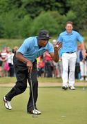 5 July 2010; Samuel L Jackson watched by Johnny Murtagh, right, salutes the crowd after putting on the 15th green during the JP McManus Invitational Pro-Am. Adare Manor, Adare, Co. Limerick. Picture credit: Diarmuid Greene / SPORTSFILE