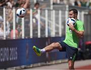 9 June 2016; John O'Shea of Republic of Ireland kicks footballs to local school children at the end of squad training at UEFA EURO2016 in Versailles, Paris, France. Photo by David Maher/Sportsfile