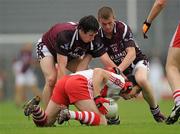 10 July 2010; Kevin McGuckin, Derry, in action against Conor Lynam, left, and Ger Egan, Westmeath. GAA Football All-Ireland Senior Championship Qualifier, Round 2, Westmeath v Derry, Cusack Park, Mullingar, Co. Westmeath. Photo by Sportsfile