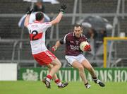 10 July 2010; Michael Ennis, Westmeath, in action against Barry McGoldrick, Derry. GAA Football All-Ireland Senior Championship Qualifier, Round 2, Westmeath v Derry, Cusack Park, Mullingar, Co. Westmeath. Photo by Sportsfile