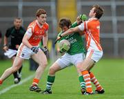 11 July 2010; Ciaran Flaherty, Fermanagh, in action against Kevin Dyas, Armagh, right, assisted by Charlie Vernon. GAA Football All-Ireland Senior Championship Qualifier Round 2, Fermanagh v Armagh, Brewster Park, Enniskillen, Co. Fermanagh. Picture credit: Oliver McVeigh / SPORTSFILE