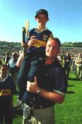1 July 2001; Tipperary manager Nicky English celebrates with young Tipperary supporter Diarmuid Fogarty during the Guinness Munster Senior Hurling Final match between Tipperary and Limerick at Páirc Uí Chaoimh in Cork. Photo by Ray McManus/Sportsfile