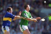1 July 2001; Brian Begley of Limerick in action against John Carroll of Tipperary during the Guinness Munster Senior Hurling Final match between Tipperary and Limerick at Páirc Uí Chaoimh in Cork. Photo by Damien Eagers/Sportsfile