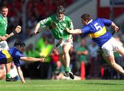 1 July 2001; Jack Foley of Limerick breaks through Philip Maher, left, and John Carroll of Tipperary during the Guinness Munster Senior Hurling Final match between Tipperary and Limerick at Páirc Uí Chaoimh in Cork. Photo by Ray McManus/Sportsfile