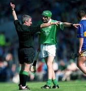 1 July 2001; Referee Pat Horan points for a free as Sean O'Connor of Limerick disputes the decision during the Guinness Munster Senior Hurling Final match between Tipperary and Limerick at Páirc Uí Chaoimh in Cork. Photo by Ray McManus/Sportsfile