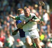 1 July 2001; Timmy Houlihan of Limerick goalkeeper is tackled by Declan Ryan of Tipperary during the Guinness Munster Senior Hurling Final match between Tipperary and Limerick at Páirc Uí Chaoimh in Cork. Photo by Ray McManus/Sportsfile