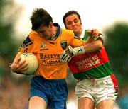 1 July 2001; Conor Connelly of Roscommon is tackled by Noel Connelly of Mayo during the Bank of Ireland Connacht Senior Football Championship Final match between Roscommon and Mayo at Dr. Hyde Park in Roscommon. Photo by David Maher/Sportsfile