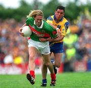 1 July 2001; Ciaran McDonald of Mayo is tackled by Francie Grehan of Roscommon during the Bank of Ireland Connacht Senior Football Championship Final match between Roscommon and Mayo at Dr. Hyde Park in Roscommon. Photo by David Maher/Sportsfile