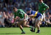 1 July 2001; Clement Smith of Limerick in action against Eugene O'Neill of Tipperary during the Guinness Munster Senior Hurling Final match between Tipperary and Limerick at Páirc Uí Chaoimh in Cork. Photo by Damien Eagers/Sportsfile