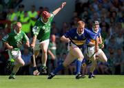 1 July 2001; Declan Ryan of Tipperary in action against TJ Ryan of Limerick during the Guinness Munster Senior Hurling Final match between Tipperary and Limerick at Páirc Uí Chaoimh in Cork. Photo by Ray McManus/Sportsfile