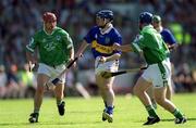 1 July 2001; Eoin Kelly of Tipperary in action against Damien Reale and TJ Ryan, left, of Limerick during the Guinness Munster Senior Hurling Final match between Tipperary and Limerick at Páirc Uí Chaoimh in Cork. Photo by Damien Eagers/Sportsfile