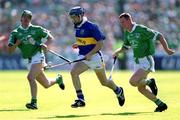 1 July 2001; Paul Kelly of Tipperary in action against Ciaran Carey of Limerick during the Guinness Munster Senior Hurling Final match between Tipperary and Limerick at Páirc Uí Chaoimh in Cork. Photo by Damien Eagers/Sportsfile