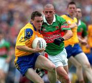 1 July 2001; Paul Noone of Roscommon in action against Trevor Mortimer of Mayo during the Bank of Ireland Connacht Senior Football Championship Final match between Roscommon and Mayo at Dr. Hyde Park in Roscommon. Photo by David Maher/Sportsfile