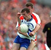 30 June 2001; Fergal Mone, Monaghan, is tackled by Armagh's John McEntee. Monaghan v Armagh, Bank of Ireland Senior Football Championship Qualifier, St. Tighearnach's Park, Clones, Co. Monaghan. Picture credit; David Maher / SPORTSTFILE