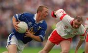 8 July 2001; Jason Reilly, Cavan, is tackled by Chris Lawn, Tyrone.  Tyrone v Cavan, Ulster Senior Football Championship Final, St. Tighearnach's Park Clones.  picture credit; David Maher / SPORTSFILE