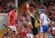 11 July 2010; Aisake Ó hÁilpín, Cork, and Declan Prendergast, Waterford, are both shown a yellow card by referee Johnny Ryan. Munster GAA Hurling Senior Championship Final, Cork v Waterford, Semple Stadium, Thurles, Co. Tipperary. Picture credit: Ray McManus / SPORTSFILE