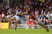 12 June 2016; Peter Acheson of Tipperary scores a point under pressure from Colm O'Driscoll of Cork during their Munster GAA Football Senior Championship Semi-Final match between Tipperary and Cork at Semple Stadium in Thurles, Co Tipperary. Photo by Piaras Ó Mídheach/Sportsfile