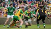 12 June 2016; Sean Quigley of Fermanagh is tackled by Anthony Thompson and Hugh McFadden of Donegal during their Ulster GAA Football Senior Championship Quarter-Final match between Fermanagh and Donegal at MacCumhaill Park in Ballybofey, Co. Donegal. Photo by Oliver McVeigh/Sportsfile