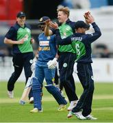 16 June 2016; Barry McCarthy of Ireland, second right, is congratulated by captain William Porterfield, right, after claiming the wicket of Dhanuska Gunathilake, second left, who was caught by Paul Stirling during the One Day International match between Ireland and Sri Lanka at Malahide Cricket Ground in Malahide, Dublin. Photo by Seb Daly/Sportsfile