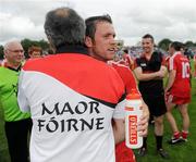 18 July 2010; Martin Penrose, Tyrone, is congratulated by assistant manager Tony Donnelly after the game. Ulster GAA Football Senior Championship Final, Monaghan v Tyrone, St Tighearnach's Park, Clones, Co. Monaghan. Picture credit: Oliver McVeigh / SPORTSFILE