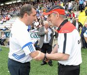 18 July 2010; Tyrone manager Mickey Harte, right, shakes hands with Monaghan manager Seamus McEnaney before the game. Ulster GAA Football Senior Championship Final, Monaghan v Tyrone, St Tighearnach's Park, Clones, Co. Monaghan. Picture credit: Oliver McVeigh / SPORTSFILE