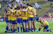 18 July 2010; Roscommon's Ger Heneghan fixes his socks as his team-mates form a huddle before the match. Connacht GAA Football Senior Championship Final, Roscommon v Sligo, McHale Park, Castlebar, Co. Mayo. Picture credit: Brian Lawless / SPORTSFILE