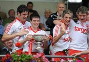 18 July 2010; Tyrone players, from left, Harry Og Conlon, Shea McGarrity, Ronan O'Neill and Richard Donnelly, celebrate with the minor cup after the game. ESB Ulster GAA Football Minor Championship Final, Tyrone v Armagh, St Tighearnach's Park, Clones, Co. Monaghan. Picture credit: Oliver McVeigh / SPORTSFILE