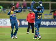 16 June 2016; Bowler Dasun Shanaka, left, and teammate Dinesh Chandimal of Sri Lanka, congratulate each other after taking the wicket of Ireland's Ed Joyce during the One Day International match between Ireland and Sri Lanka at Malahide Cricket Ground in Malahide, Dublin. Photo by Seb Daly/Sportsfile