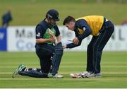 16 June 2016; Ireland reserve player George Dockrell, right, helps to fix captain William Porterfield's bat during a break in play during the One Day International match between Ireland and Sri Lanka at Malahide Cricket Ground in Malahide, Dublin. Photo by Seb Daly/Sportsfile