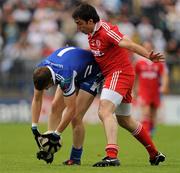 18 July 2010; Darren Hughes, Monaghan, picks up the ball legally under pressure from Joe McMahon, Tyrone. Ulster GAA Football Senior Championship Final, Monaghan v Tyrone, St Tighearnach's Park, Clones, Co. Monaghan. Picture credit: Brendan Moran / SPORTSFILE