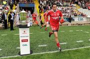 18 July 2010; Tyrone's Davy Harte runs out past the Anglo Celt cup before the game. Ulster GAA Football Senior Championship Final, Monaghan v Tyrone, St Tighearnach's Park, Clones, Co. Monaghan. Picture credit: Brendan Moran / SPORTSFILE