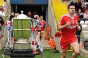 18 July 2010; Tyrone's Sean Cavanagh runs out past the Anglo Celt cup before the game. Ulster GAA Football Senior Championship Final, Monaghan v Tyrone, St Tighearnach's Park, Clones, Co. Monaghan. Picture credit: Brendan Moran / SPORTSFILE