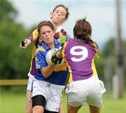 24 July 2010; Shauna Ryan, Tipperary, in action against Aisling Murphy and Sarah Roche, Wexford. Ladies Gaelic Football Minor B All-Ireland Final, Wexford v Tipperary, Freshford GAA Grounds, Freshford, Co. Kilkenny. Picture credit: Ray Lohan / SPORTSFILE
