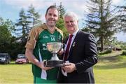 18 June 2016; Uachtarán Chumann Lúthchleas Gael Aogán Ó Fearghail presents the Wolfe Tone Cup to captain Mark Ryan after the Britain's Provincial Junior Shield Final match between Hertfordshire and Yorkshire at Frongoch in Gwynedd, Wales. Photo by Paul Currie/Sportsfile