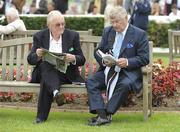 26 July 2010; Former EU Commissioner Ray MacSharry, right, and retired MP Mark Killilea relax after their first winners in the jurysinn.com Handicap Hurdle. Galway Racing Festival 2010, Ballybrit, Galway. Picture credit: Ray McManus / SPORTSFILE