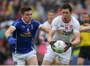 19 June 2016; Sean Cavanagh of Tyrone in action against Tomas Corr of Cavan during the Ulster GAA Football Senior Championship Semi-Final match between Tyrone and Cavan at St Tiernach's Park in Clones, Co Monaghan. Photo by Oliver McVeigh/Sportsfile