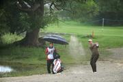 28 July 2010; Darren Clarke, watched by his caddy Brendan McCartan, plays from the sand trap on the first fairway . 3 Irish Open Golf Championship - Pro Am, Killeen Course, Killarney Golf & Fishing Club, Killarney, Co. Kerry. Picture credit: Matt Browne / SPORTSFILE