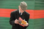 28 July 2010; Patrick O'Gorman, from O'Gorman's Cross, Cratloe, Co. Clare, reads his race card before racing. Galway Racing Festival 2010, Ballybrit, Galway. Picture credit: Ray McManus / SPORTSFILE