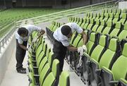 30 July 2010; Groundstaff clean the stadium seats ahead of the combined provinces match to mark the opening of the new Aviva Stadium on Saturday. Aviva Stadium, Lansdowne Road, Dublin. Picture credit: Barry Cregg / SPORTSFILE