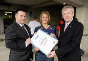 31 July 2010; Winner of the 1,000,000th Championship Spectator 2010 Sandry Clancy, from Moyvane, Co Kerry, is presented with her certificate by Peter McKenna, Stadium Director, Pairc an Chrocaigh Teoranta, left, and Páraic Duffy, Ard Stiúrthóir, Chumann Lúthchleas Gael. Sandra is the winner of two premium tickets to the All-Ireland Football Final 2010, a nights stay in the Croke Park Hotel Suite before the game and tickets for the Final Countdown event at Croke Park on the eve of the final. The 1,000,000th Championship Spectator of 2010, Croke Park, Dublin. Picture credit: Ray McManus / SPORTSFILE