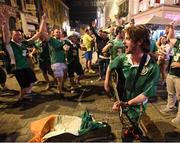 22 June 2016; Musician Richy Sheehy, from Carrignavar, Co. Cork, entertains Republic of Ireland supporters after their victory during the UEFA Euro 2016 Group E match between Italy and Republic of Ireland in Lille, France. Photo by Stephen McCarthy/Sportsfile