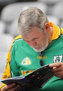 1 August 2010; A Meath supporter reading the programme at the game. Supporters at the GAA Football All-Ireland Senior Championship Quarter-Finals, Croke Park, Dublin. Picture credit: Oliver McVeigh / SPORTSFILE