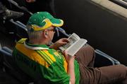 31 July 2010; A Kerry supporter reads a book before the game. Supporters at the GAA Football All-Ireland Senior Championship Quarter-Finals, Croke Park, Dublin. Picture credit: Ray McManus / SPORTSFILE