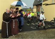 24 June 2016; 100 cyclists set off on their 2 day journey from the Capuchin Day Centre in Smithfield to Belmullet, Co. Mayo. The cyclists, among them Mayo legend David Brady, are closing in on their fundraising target of €100,000 which will go directly to the Capuchin Day Centre which has been providing relief for the homeless since 1969. Pictured is Brother Kevin Crowley, far left, as he applauds cyclsits as they leave on their journey. Capuchin Day Centre, Smithfield, Dublin. Photo by Seb Daly/Sportsfile